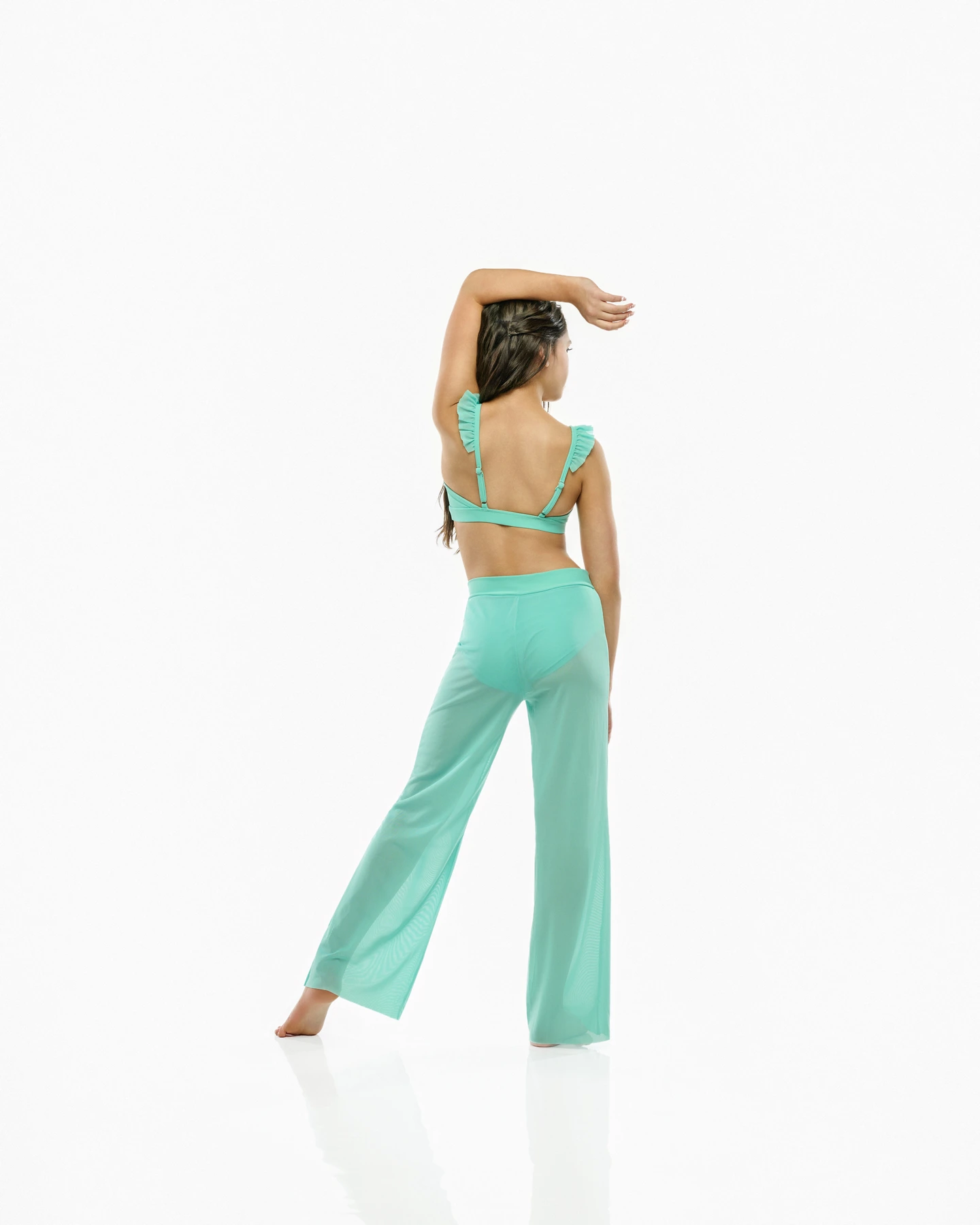 Turquoise dance top and flowing pants, photographed from behind
