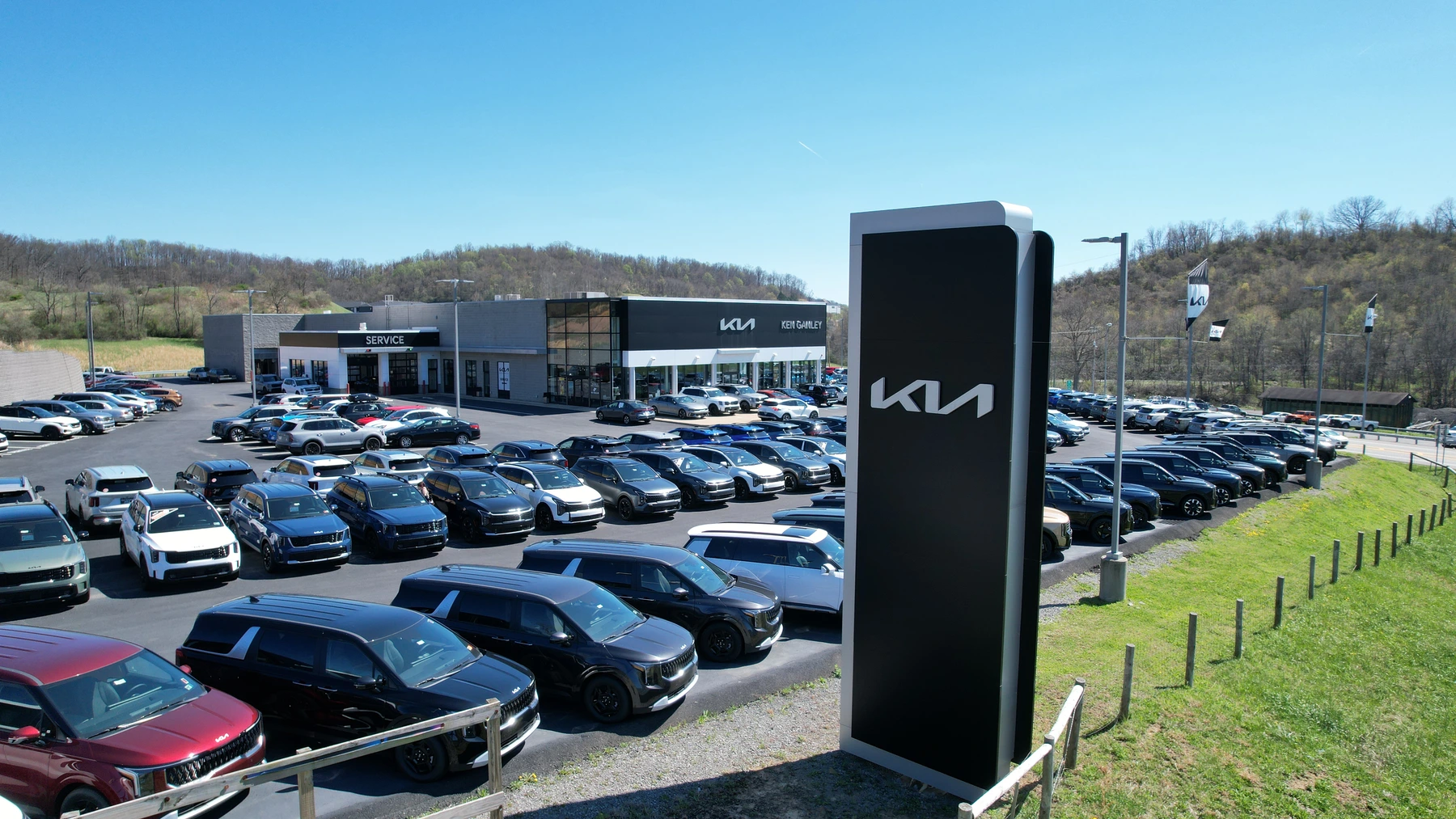Aerial view of the Ken Ganley Kia dealership, vehicle lot, and Kia sign