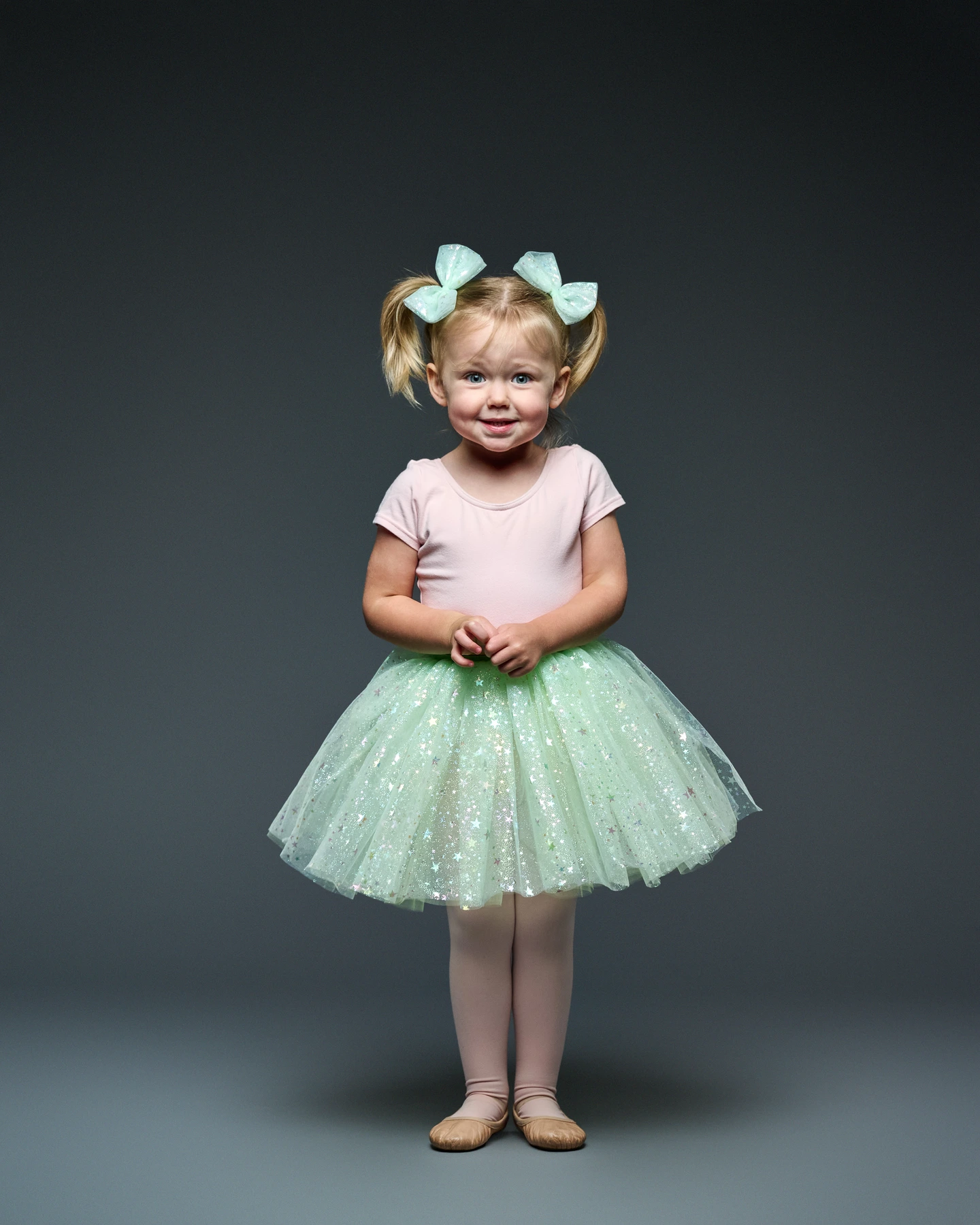 Child modeling a mint green tutu and matching hair bows