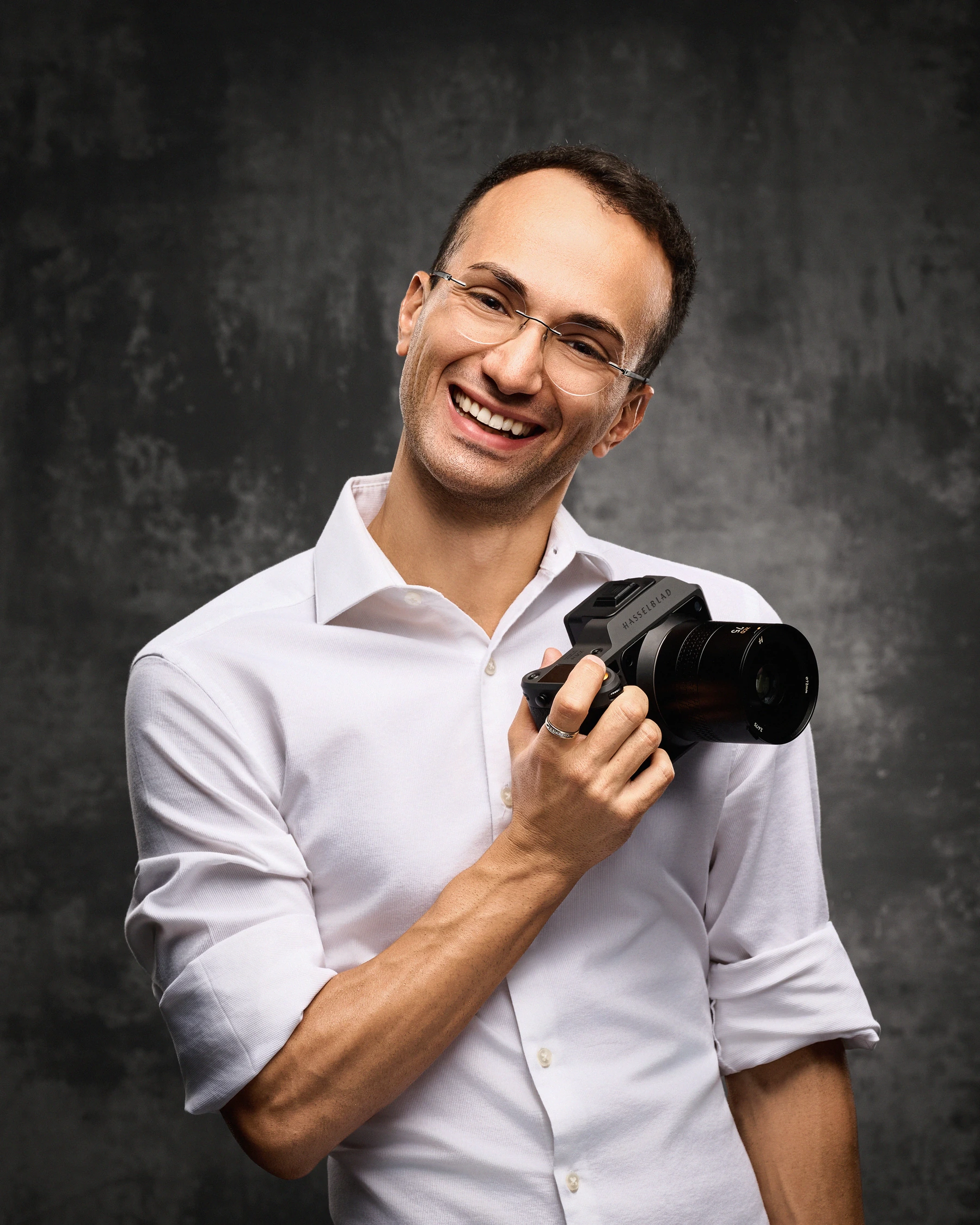 Luca Sportelli smiling while holding his camera