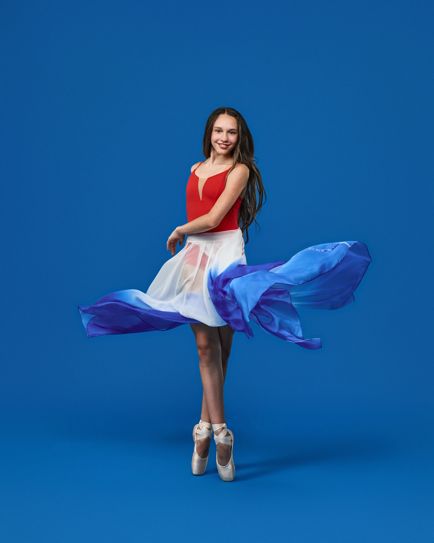 Ballerina en pointe with a flowing red white and blue skirt