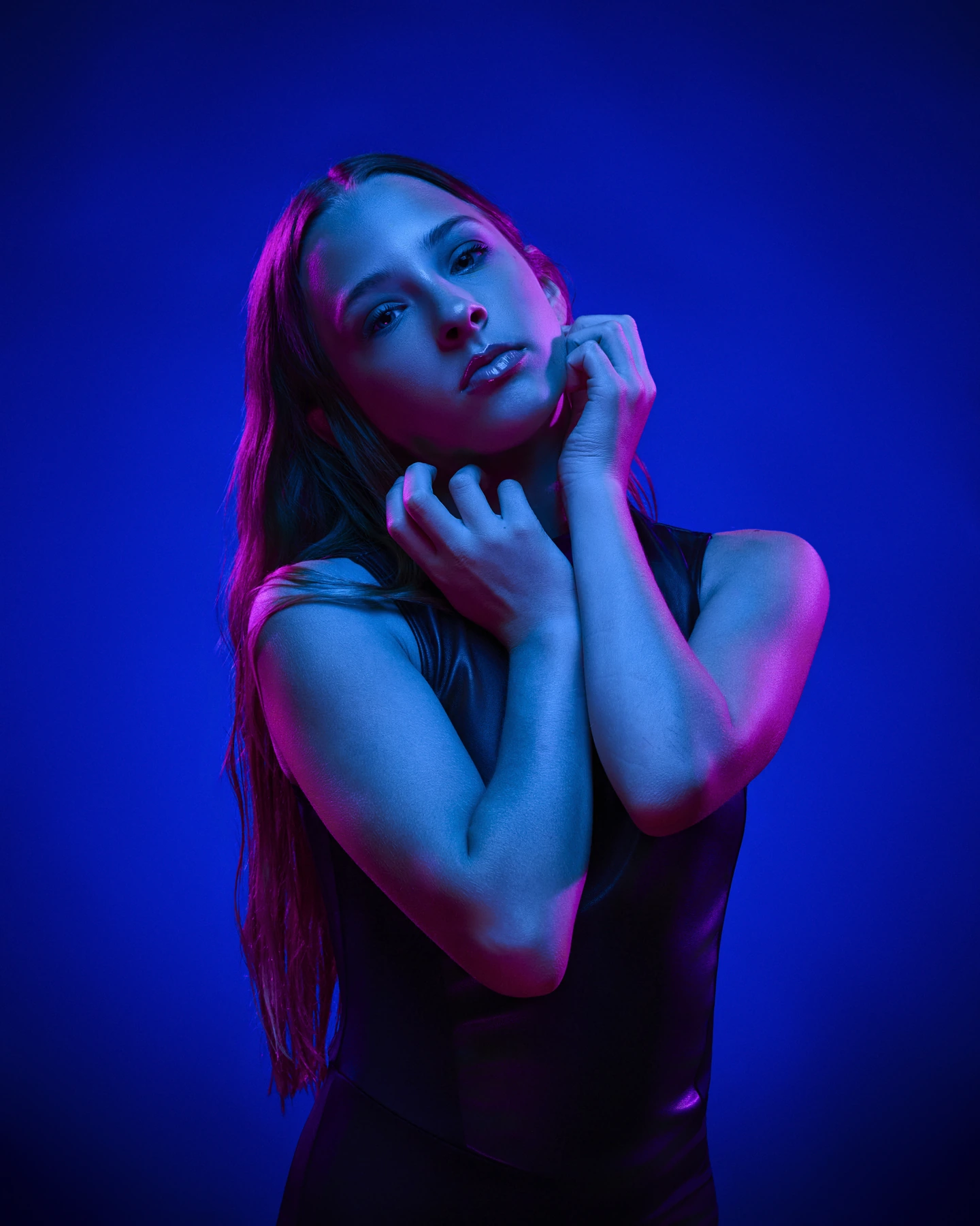 Portrait illuminated with blue and magenta studio lighting