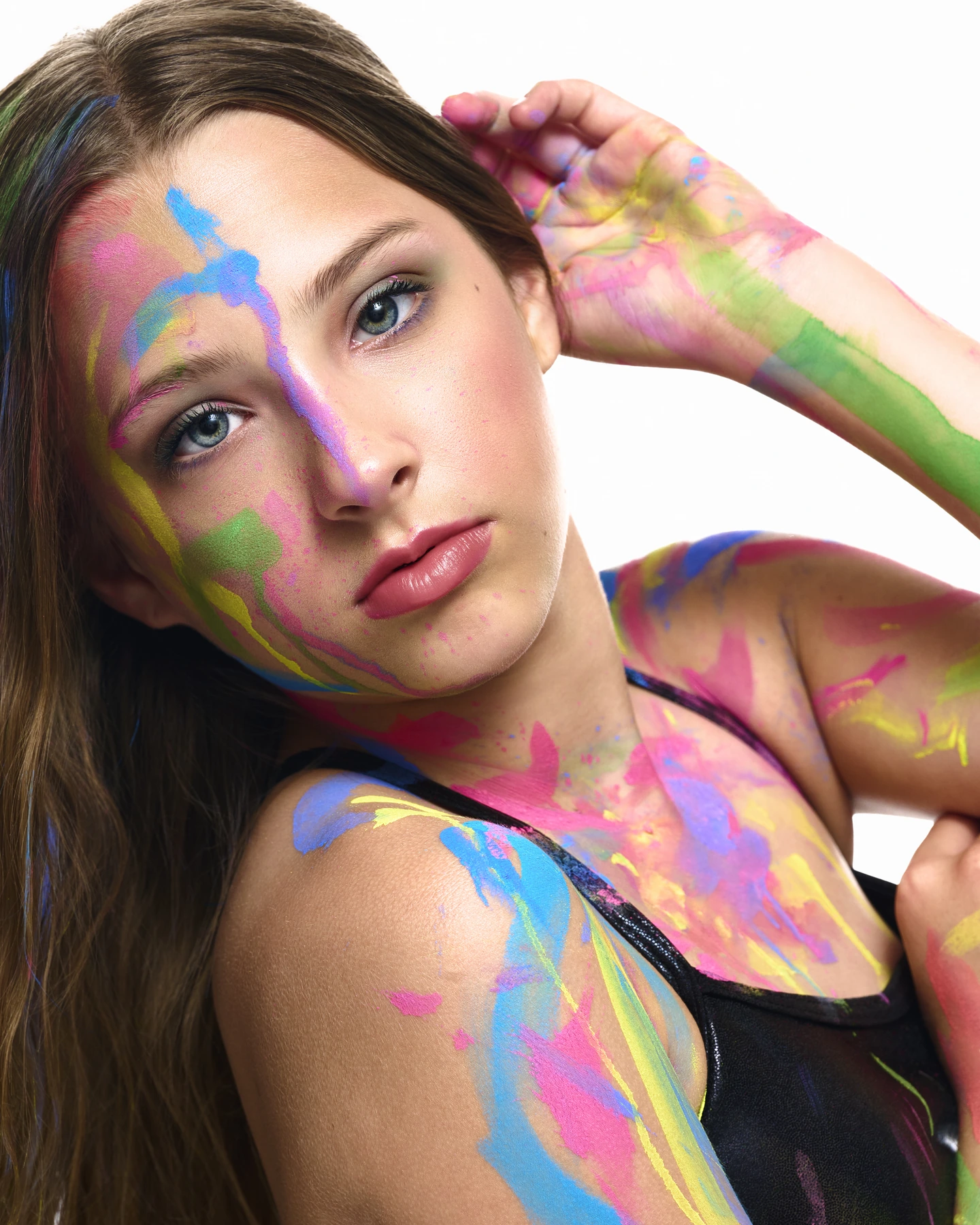 Close portrait with colorful paint against white