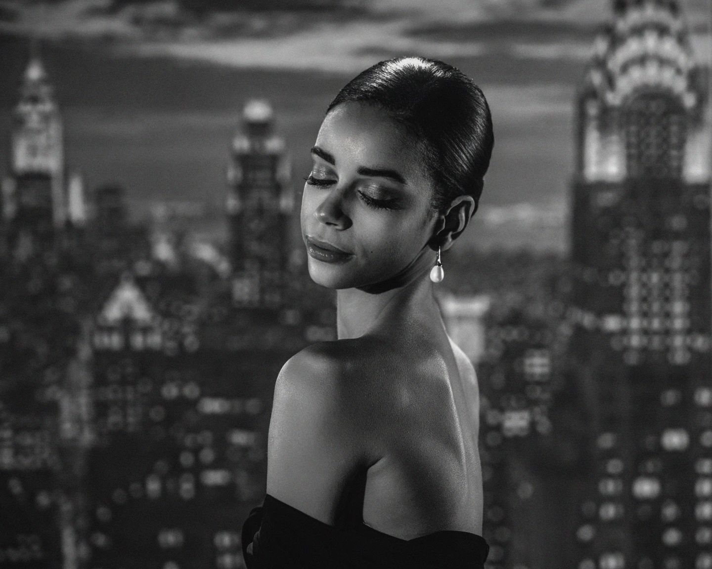 Black and white portrait looking over one shoulder against projected architectural shadows